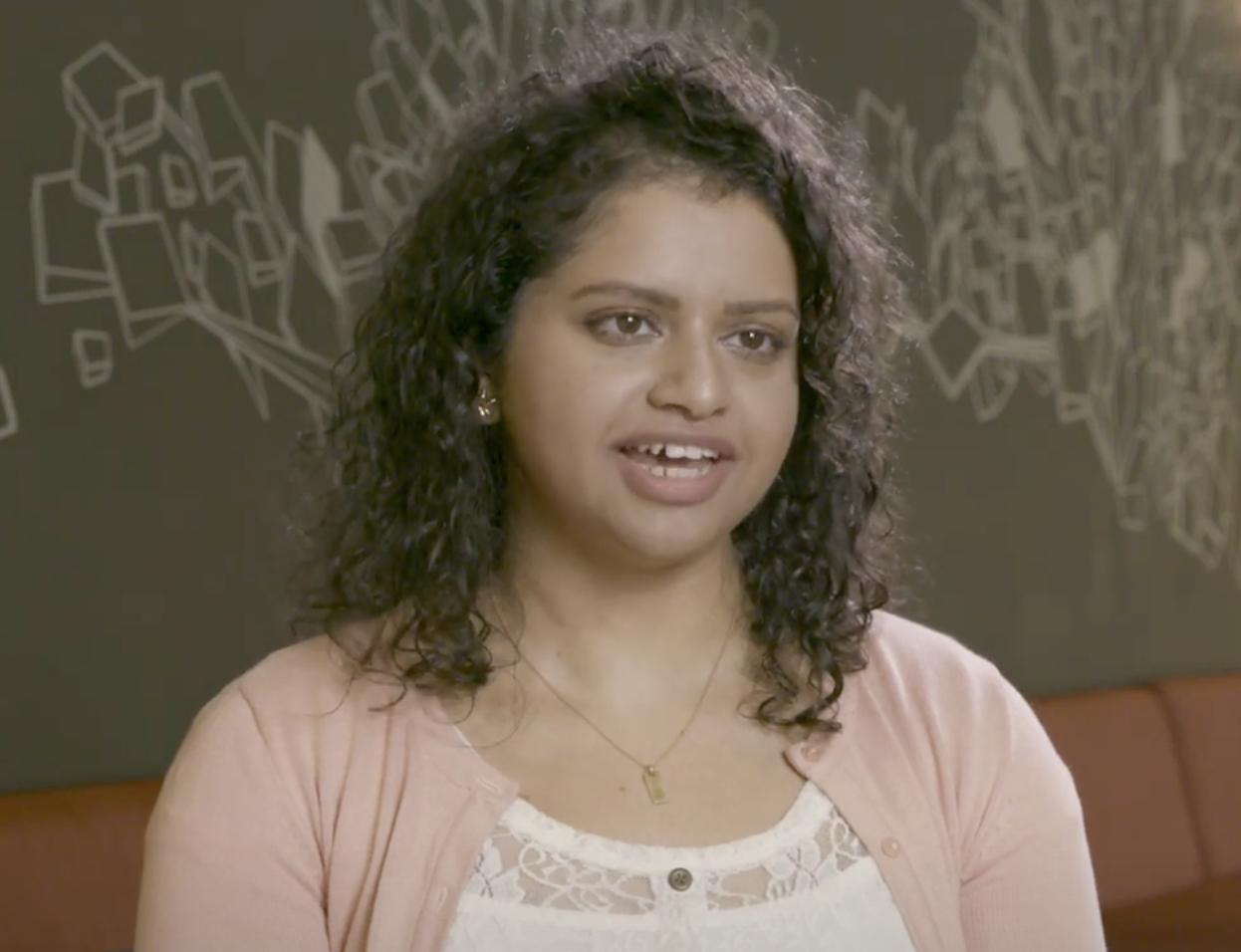 Head and shoulders of a young woman speaking